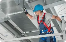 man inspecting AC